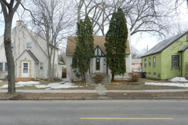 A streetview of 3 story and a half houses that appear to have been built around the 1940's