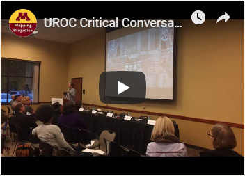 Still from a video showing a presentation to a crowd, with text: "UROC Critical Conversation..." and the U of M Mapping Prejudice logo